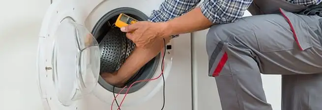 Dryer repair technician inspecting and repairing a clothes dryer in Little Rock, AR
