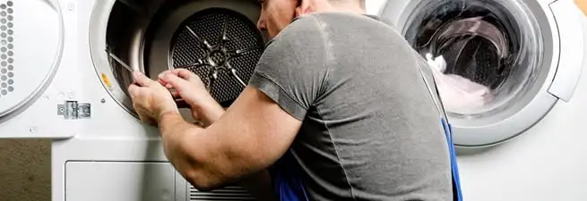 Dryer repair technician fixing a clothes dryer drum in Little Rock, AR