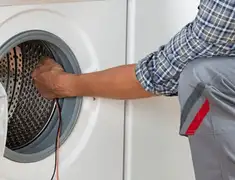 Dryer repair technician diagnosing and servicing a clothes dryer in Little Rock, AR