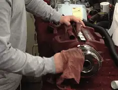Vacuum repair technician cleaning and servicing a vacuum motor in Little Rock, AR